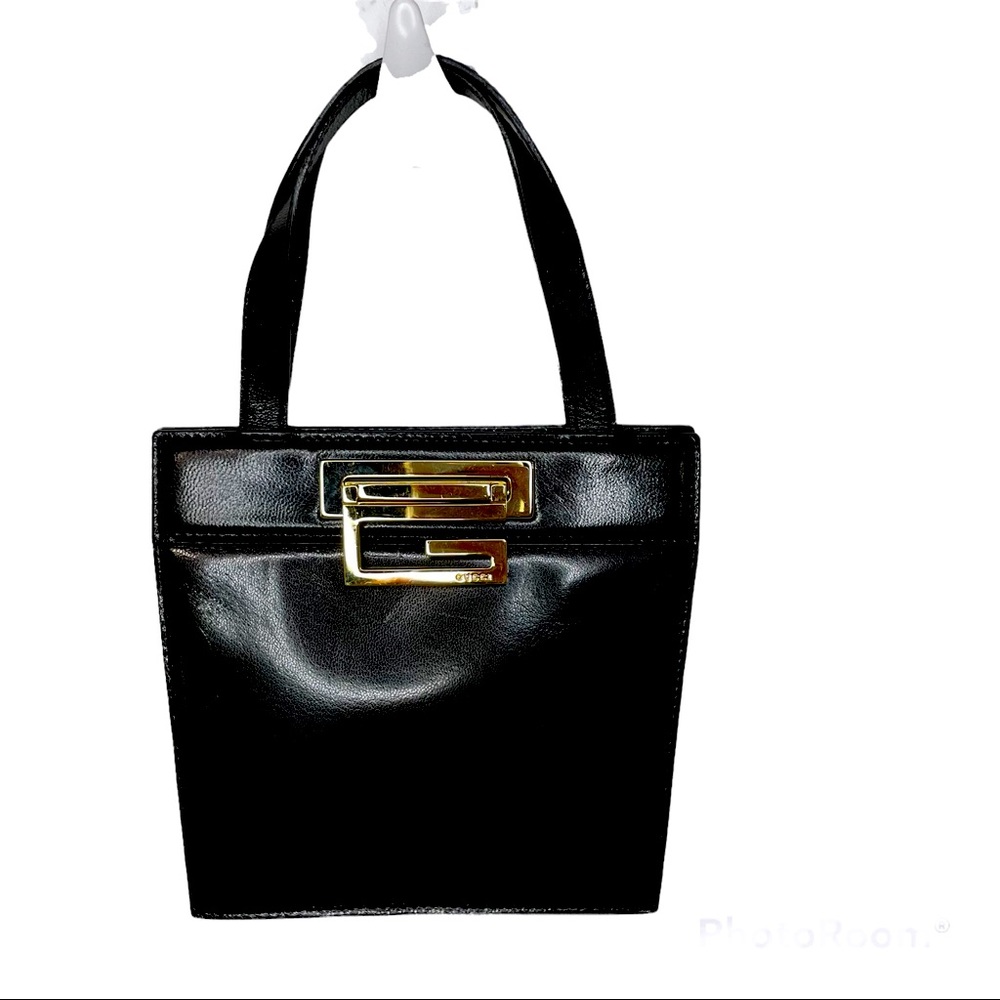 Gucci small black bag with gold buckle including dust bag.  Very clean.